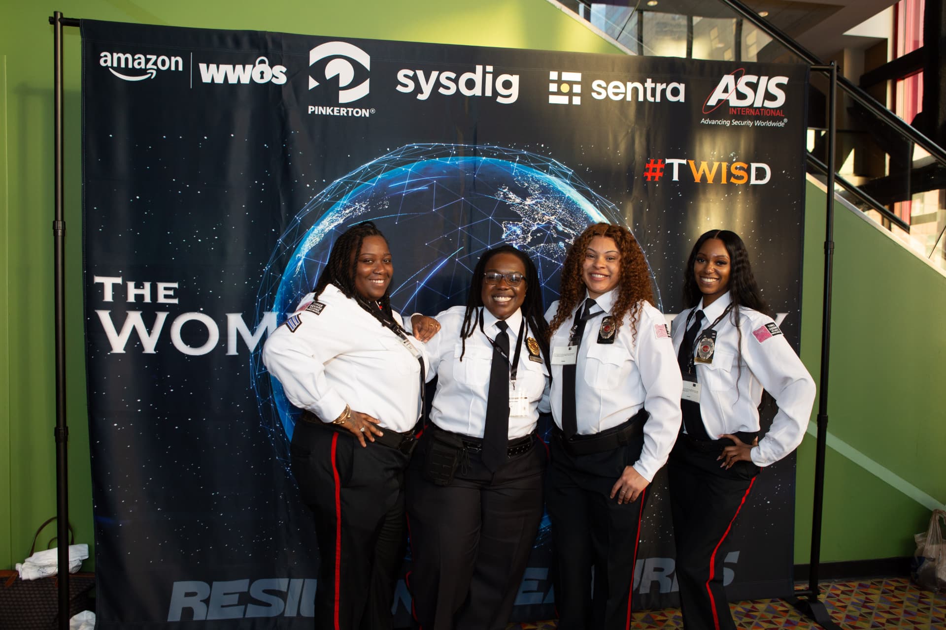 Uniformed security officers in front of the film backdrop